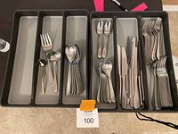 Full view of all silverware organized in six-compartment Madesmart tray including forks, knives, spoons, and serving pieces.
