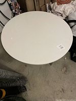 Overhead view of round white stone tabletop of the coffee table.