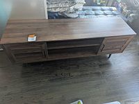 Top and front view showing length and doors on sides with handles, open center shelves.