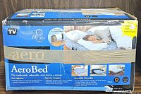 Blue AeroBed box showing images and text detailing features of the adjustable comfort air mattress including fast inflation, superior comfort, and versatility.