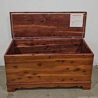 Front open view of solid wood blanket chest with natural wood grain and internal storage space visible.