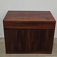 Front view of closed cabinet showing veneer grain and door fronts