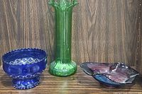 Showing full set of three glass items: cobalt blue bowl, green ruffled vase, and multicolor candy dish