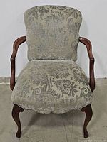 Front view showcasing the patterned upholstery, cushion seat and wood arms and legs.