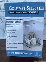 Boxed Cabinet Pro Gourmet Select 14 1/2 inch sliding tray with professional cabinet solution branding on front, showing product features and usage image with kitchen dishware on sliding tray.