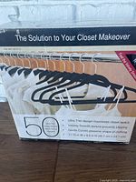 Box of 50 black velvet smooth texture hangers showing the product image and details.