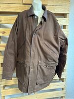 Front view of brown Alaska Bay winter coat with button closure and multiple pockets on a mannequin.