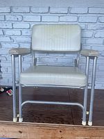 Front view of the EZ-In aluminum framed chair with padded seat and backrest showing the sailfish embossed design.