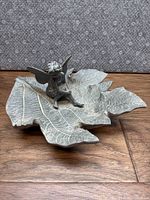 Full view of garden angel/fairy seated on leaf-shaped base showing overall shape and size.