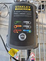 Front view of the Stanley FatMax 8 amp charger showing LED indicators, mode selector knob, and branding.