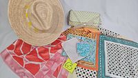 Overview of all items including the straw sun hat, two scarves, leopard print clutch, and patterned pouch