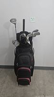 Front view of the golf bag filled with golf clubs including irons and driver