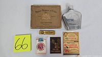 Shows vintage Philip Morris cigarette box, metal flask, cigarette packs, and paper advertisements together with lot number.