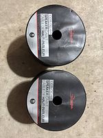 Top view of two black reels with labels showing "100ft (30.4m) Speaker Cable 16 Gauge" from Rocketfish.