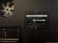 Close-up of the identification plate on the back showing model TP-762, power source 120V AC 60Hz, power consumption 40W, serial number 00394, manufactured by Carrady-Haitai Co. Ltd. Toronto, made in Japan.