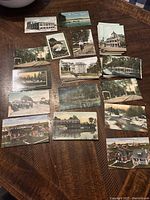 14 antique postcards laid out on a wooden surface, showing various buildings, streets, and waterfront scenes from Cambridge, Ontario