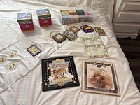 Multiple Bragging Rights and wedding memory books, photo frames and decorative gift boxes displayed on a bed.