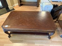 Top view of the large wooden coffee table showing the wood grain surface and minor scratches.