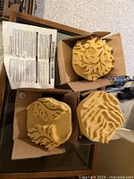 Three yellow carved wall art sponges in cardboard boxes, showing each unique pattern and indicating the lot contains three new items as per seller