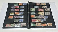 Open binder showing multiple pages of British Commonwealth stamps including the 1937 Coronation series, sorted by denomination and color with clear visibility of details.
