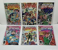 Front view of the 6 Marvel Secret Wars comic issues in bagged and boarded condition showing cover art.