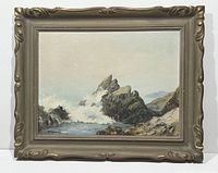 Full view of framed oil painting showing rocky coast and ocean waves under light sky.