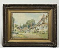 Framed watercolour painting showing rural thatched cottages and a woman walking on a path, signed S. Sinclair in bottom left.