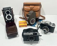 Overview of all cameras, cases, manual and film boxes laid out