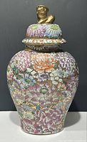 Overall profile of vase with lid in place showing full painted floral design