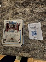 Photo of the hockey card box and auction label on a granite-style surface.