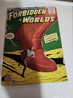 Front cover of Forbidden Worlds Issue 66 comic showing large red boot and man shrinking, with visible wear and discoloration around edges.