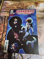 Front cover of Guardians of the Galaxy #1 comic showing characters on a space-themed background with a prominent black ampersand.