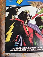 Close-up photo showing the detailed cover art of Peter Parker The Spectacular Spider-Man #51, including characters and credits.