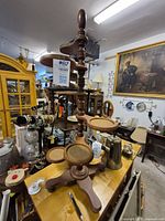 Photo of the wooden 5 tier plant stand showing dark wood, turned spindle legs, and circular platforms.
