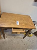 Full view of wooden desk with single drawer showing overall condition and size