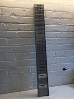 Front view of the metal time card holder showing multiple slots for inserting cards in vertical alignment.