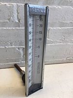 Side angle of Trerice thermometer showing Fahrenheit scale from 0 to 70 and Celsius scale from 170 to 270 with metal frame and attached probe.