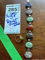 Ring and bracelet on wood table with label