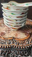 Stack of 7 ceramic bowls with dragon and phoenix designs, showing side profiles and patterns.