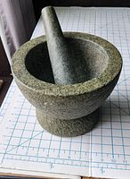 Mortar and pestle angled to show size and base