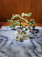 Front view of the Lucky Jade Tree showing green jade leaves on gold wire branches sitting on a split agate base.