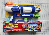 Front view of Nerf Super Soaker Arctic Shock water gun in original packaging on measurement grid