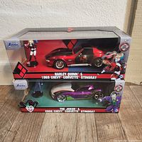Front view of the two sealed sets stacked, showing 1969 Harley Quinn & 2009 Joker Chevy Corvette Stingrays in packaging.