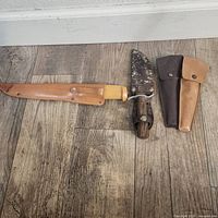 J Martini fish fillet cutter with yellow handle and tan leather sheath, Japanese cutter with sheath showing blade patina, and two Boy Scouts leather pouches.