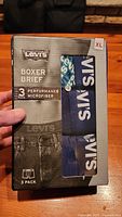 Front of the Levi's 3-pack boxer briefs box showing size, branding, and visible briefs colors