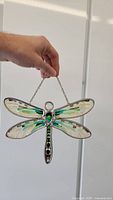 Front view of the Amia stained glass dragonfly hanging decoration, showing wing colors and metal frame.