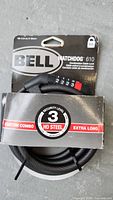 Front view of Bell Watchdog 610 combo lock in packaging showing lock mechanism and cable.