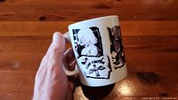 White ceramic mug with black and white images of Blondie band members and related text.