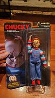 Front view of Chucky action figure in packaging showing figure and box with visible wear.