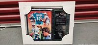 Front view of collectable plaque in packaging showing Dan Marino collage and career highlight plaque.